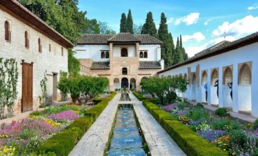 Generalife gardens in Alhambra Granada with water fountains, long pool and landscaped Islamic gardens