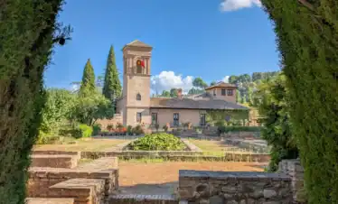 Alhambra towers overlooking Generalife gardens in Granada with fortress walls and landscaped terraces
