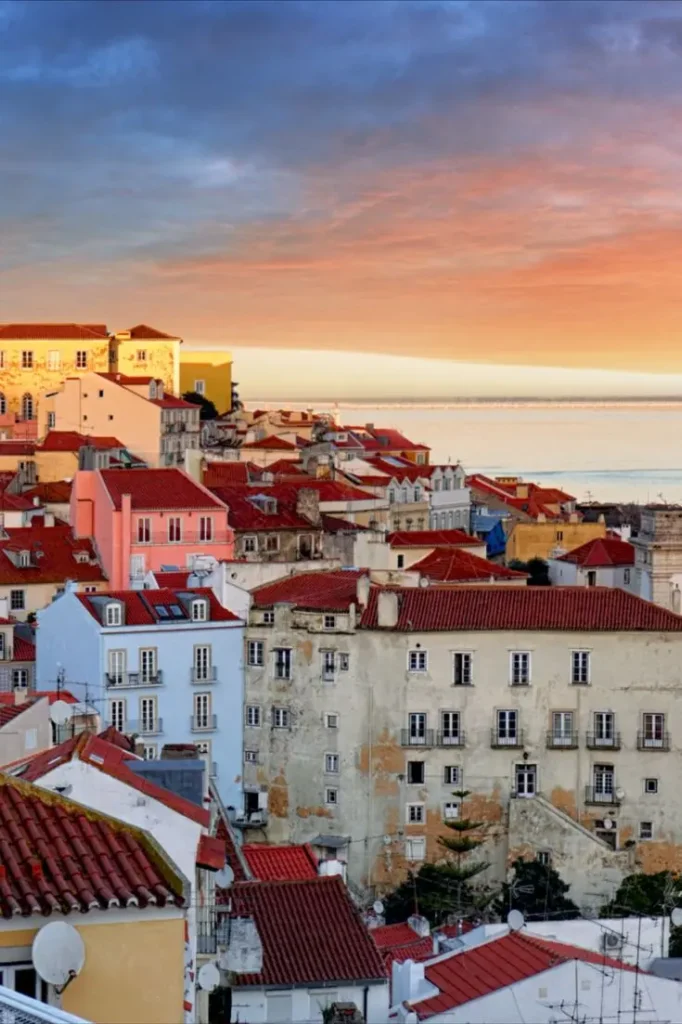 Panoramic view of the Alfama district in Lisbon with its historic tile-covered buildings.